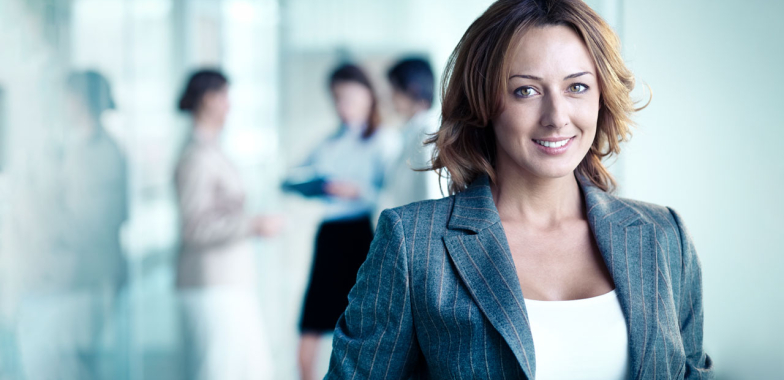 Business woman with team in background out of focus