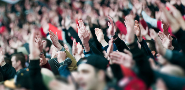 Large crowd with their hands in the air