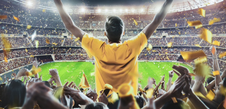 Football stadium with fan in yellow shirt