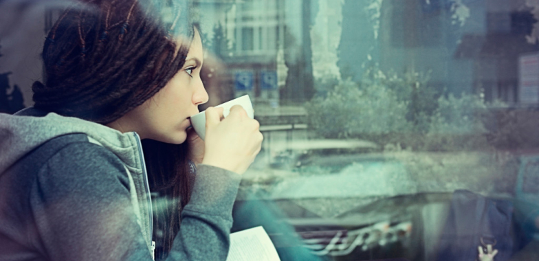 Woman in café drinking from mug