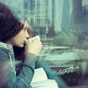 Girl in cafe drinking from cup