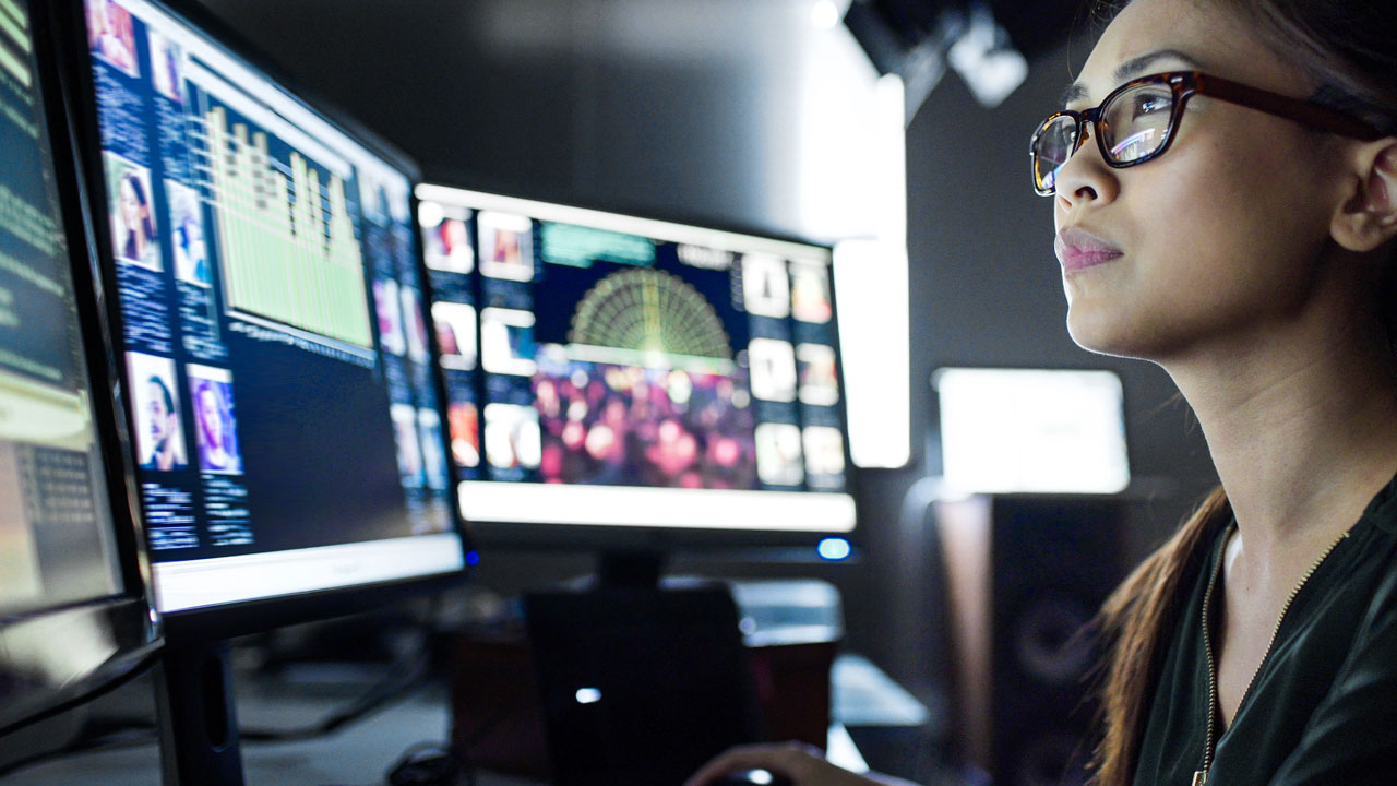 Forensic woman at computer screen
