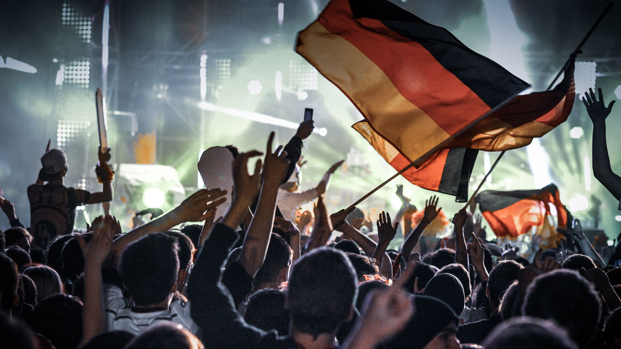 Large crowd waving German flags