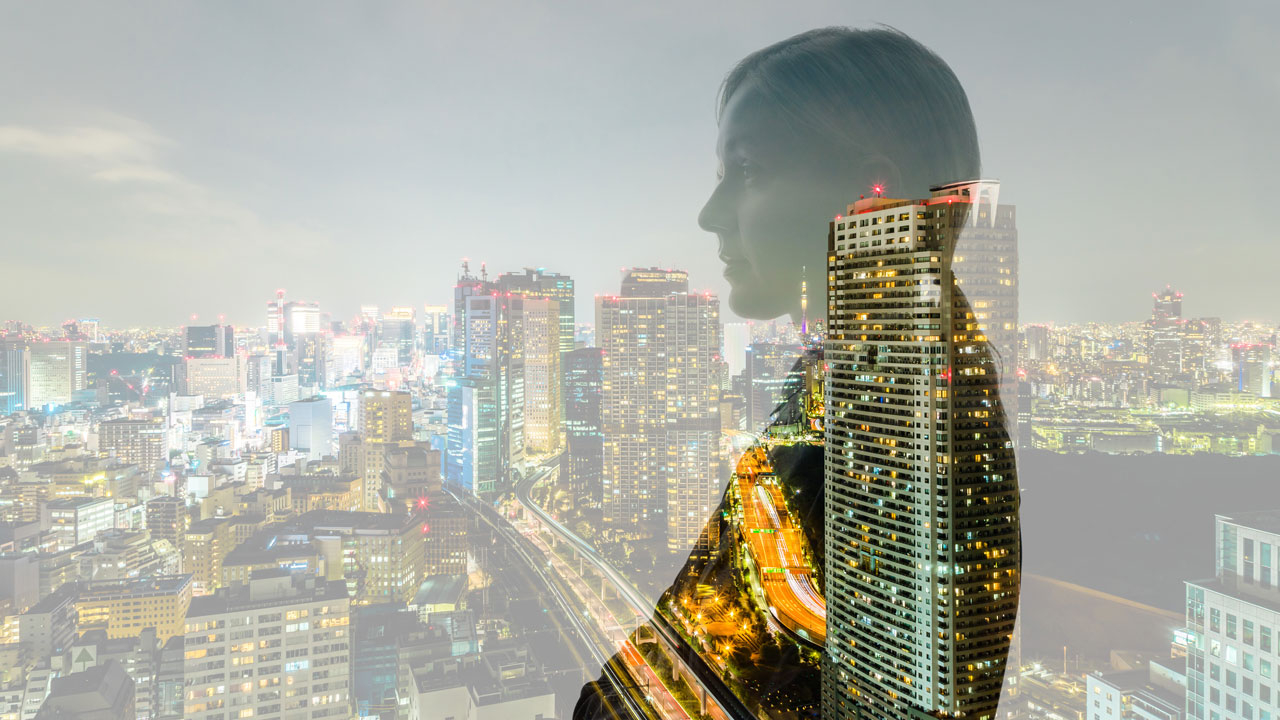 Side profile of woman with cityscape in background