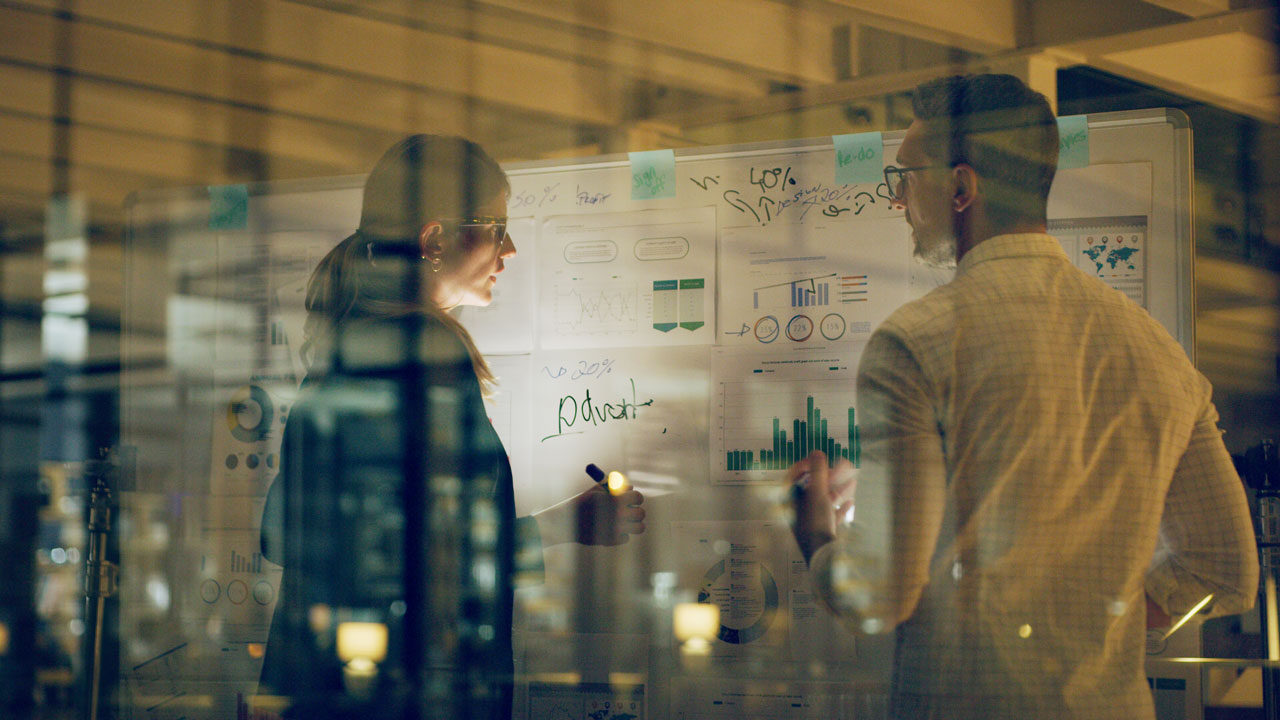 People looking at a white board