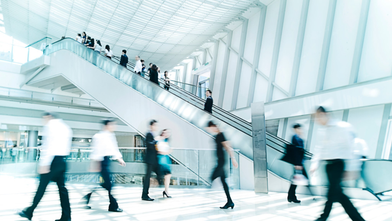 Foyer with escalator and people walking