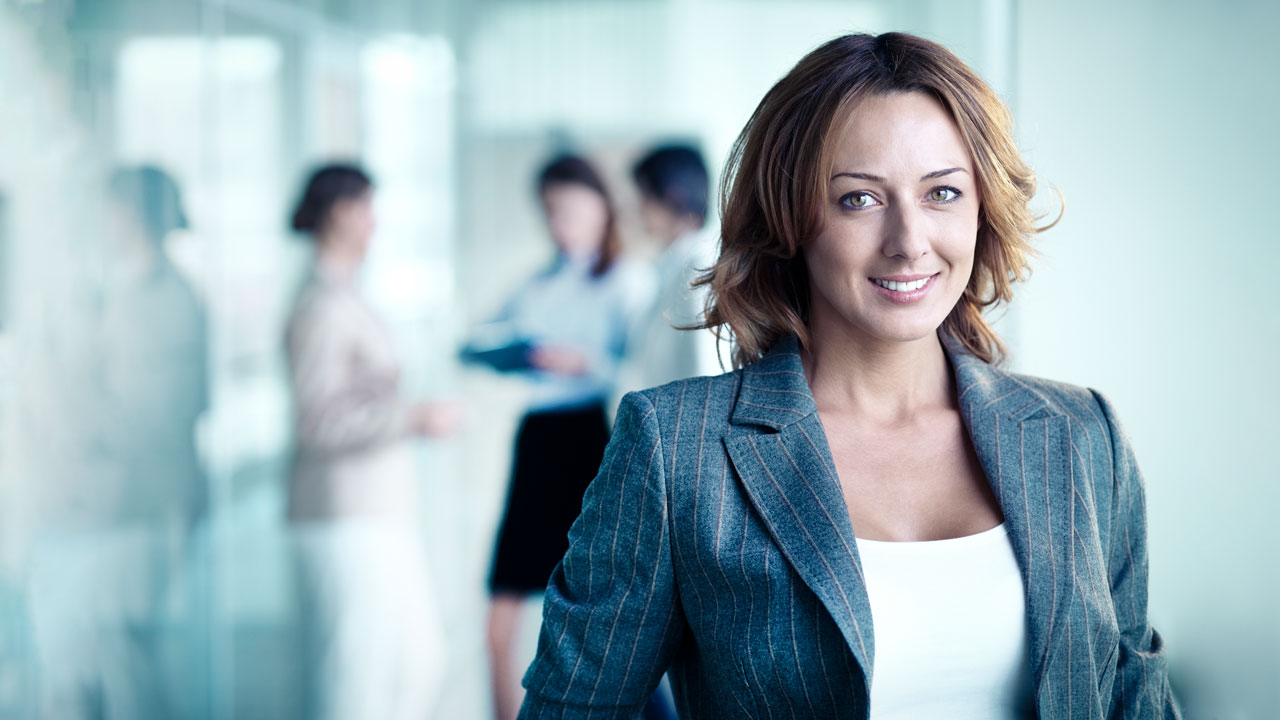 Business woman with team in background out of focus