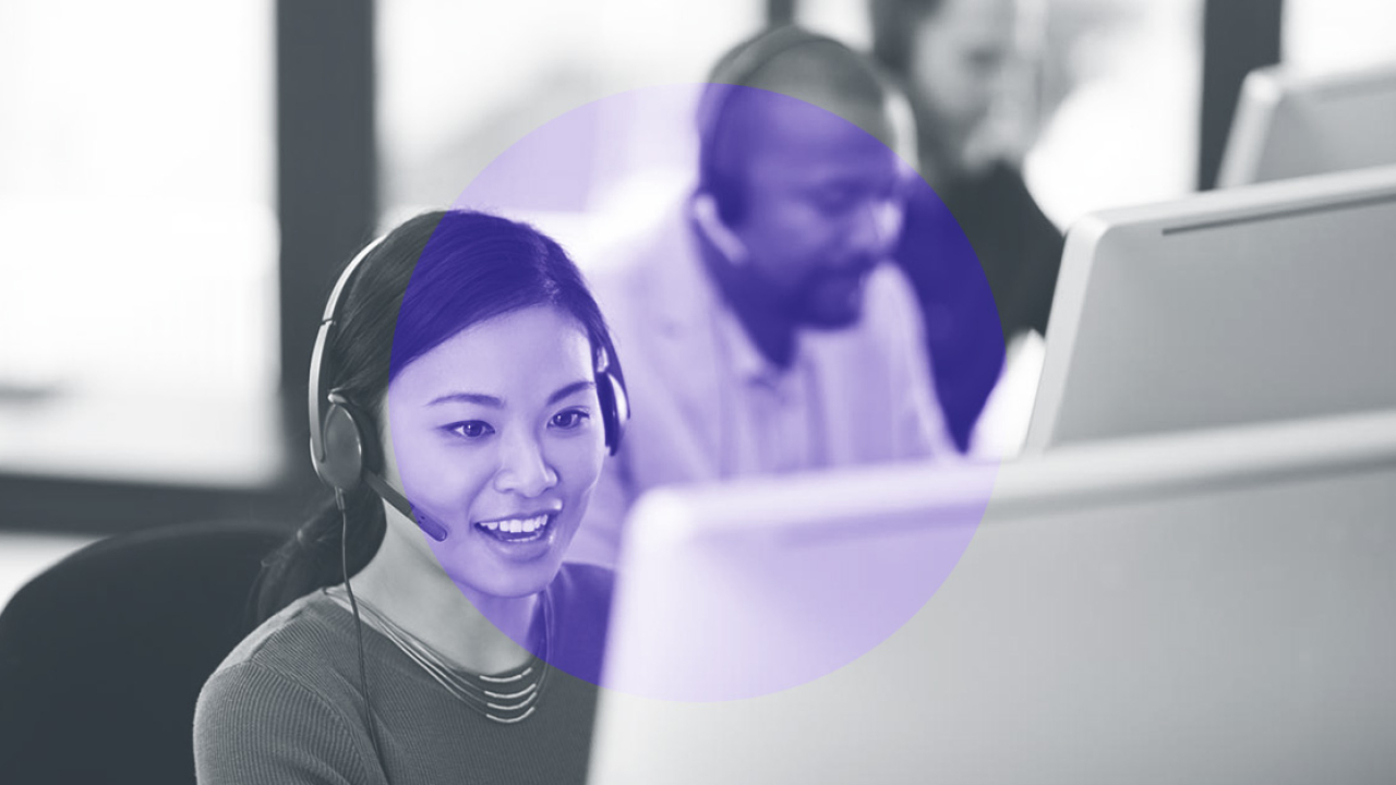 Call centre employees in front of computer screens