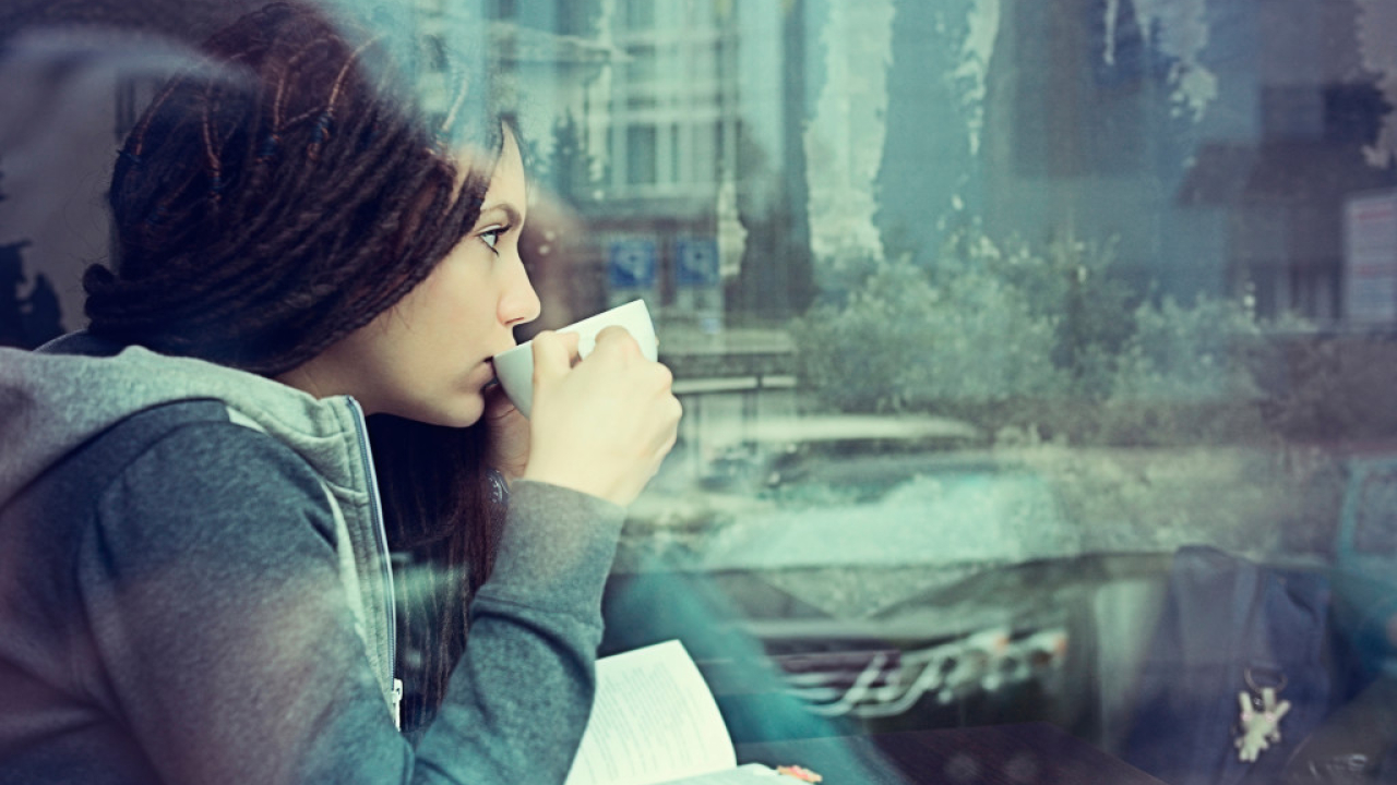 Woman in café drinking from mug
